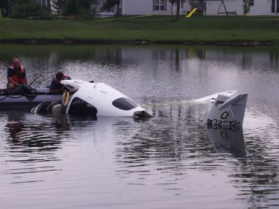 ER-0006
Photo Date: 7/31/2001
Photo Credit: Jason Ravenscroft
Description: Small plane crash into residential subdivision retention pond.

