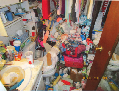 HH-0043
Photo Date: January 16, 2020
Photo Credit: Jeff Couch and Peggy Bradley
Description: The photo was taken in the only bathroom in the house. There is a bathtub in this picture filled with clothes and other stuff.  The whole house was piled almost to the ceiling.  
